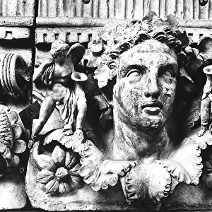 Terracotta relief with heads and festoons from the Apulia region, close up; the work is preserved in the Gregorian Etruscan Museum of the Vatican Museums in Vatican City