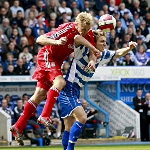Kevin Doyle and Sami Hyypia jump for the ball